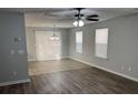 Open-concept living area with wood-look flooring and ample natural light from windows with blinds at 3518 Sable Glen, South Fulton, GA 30349