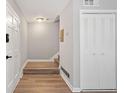 Bright entryway featuring wood-look floors, coat closet, and easy access to staircase at 382 Leisure Sw Ct, Marietta, GA 30064
