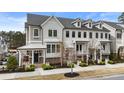 Attractive townhome with porch, dormer windows and professional landscaping at 884 Mayfield Rd, Milton, GA 30009