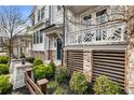 Inviting townhome exterior with a porch, manicured shrubs and attractive architectural details at 884 Mayfield Rd, Milton, GA 30009