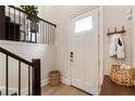 Bright foyer with hardwood floors, coat hooks, and convenient access to the staircase at 884 Mayfield Rd, Milton, GA 30009