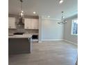 A kitchen with white cabinets, stainless appliances and a hanging light fixture at 1979 Deco Dr, Kennesaw, GA 30144