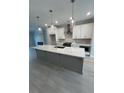 Kitchen featuring stainless steel appliances, white cabinets, and a spacious gray island at 1979 Deco Dr, Kennesaw, GA 30144