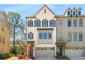Charming two-story townhome with brick facade, gray shutters, and attached two-car garage at 2468 Skyland Ne Dr # 32, Atlanta, GA 30319