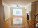 Sunny living room featuring hardwood floors, a large window, and a fireplace at 2921 Royston Dr, Duluth, GA 30097