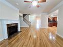 Spacious living room featuring a fireplace, hardwood floors, and a staircase at 2921 Royston Dr, Duluth, GA 30097