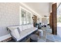Inviting covered porch with slate flooring, comfortable seating, and stylish decor at 3680 Sewell Mill Rd, Marietta, GA 30062