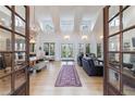 Bright open-concept living room with soaring ceilings and hardwood floors at 3680 Sewell Mill Rd, Marietta, GA 30062