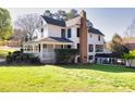Charming home featuring a covered porch and lush landscaping, creating a welcoming curb appeal at 1768 Hood Rd, Dacula, GA 30019