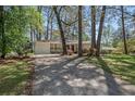 Ranch style home with mature trees, brick accents, and driveway at 1863 Bruce Ne Rd, Atlanta, GA 30329