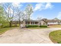 Inviting single-Gathering home featuring a well-manicured lawn and ample parking space at 2285 Bascomb Carmel Rd, Woodstock, GA 30189