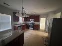 Kitchen features wood cabinets, granite counters, and stainless steel appliances at 5761 Harrier Ln, Atlanta, GA 30349