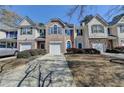 Inviting townhome featuring well-kept landscaping and a private driveway leading to attached garage at 5835 Terremont Cir, Norcross, GA 30093