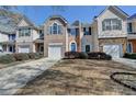 Well-maintained townhome with a clean driveway, charming curb appeal, and an attached garage at 5835 Terremont Cir, Norcross, GA 30093