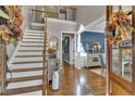 Elegant foyer with hardwood floors, staircase, and decorative accents at 121 Rising Star Rd, Fayetteville, GA 30215