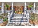 Inviting front porch with a double-door entrance and decorative wreaths and flower pots at 121 Rising Star Rd, Fayetteville, GA 30215
