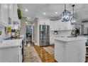 Modern white kitchen with stainless steel appliances, ample counter space, and stylish lighting at 121 Rising Star Rd, Fayetteville, GA 30215
