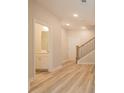 Hallway features hardwood floors, access to the bathroom, staircase, and door at 1991 Deco Dr, Kennesaw, GA 30144