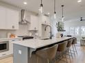 Modern kitchen with a spacious island, white cabinetry, and stainless steel appliances at 1991 Deco Dr, Kennesaw, GA 30144