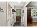 Bright foyer with coat closet and hardwood floors transitioning into living space at 205 Glencourtney Dr, Sandy Springs, GA 30328
