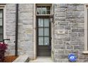 Exterior front door featuring stone detailing with an ADT security sign at 269 Devin Ne Pl, Atlanta, GA 30305