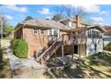 Exterior backyard view with a wood deck and stairs down to the patio at 5269 Wyntercreek Dr, Atlanta, GA 30338