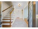 Inviting foyer with tile floors, wooden staircase, and a decorative front door at 5269 Wyntercreek Dr, Atlanta, GA 30338