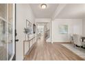 Bright entryway with wood floors, modern decor, and open access to other rooms at 1079 Georgian Point Dr, Lawrenceville, GA 30045