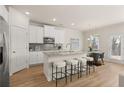 Beautiful kitchen with white cabinets, stainless steel appliances, granite countertops and a long island with barstool seating at 1079 Georgian Point Dr, Lawrenceville, GA 30045