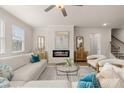 Bright living room features a fireplace, ceiling fan, and windows that bring in plenty of natural light at 1079 Georgian Point Dr, Lawrenceville, GA 30045