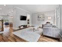 Open-concept living room featuring hardwood floors and stylish decor and furnishings at 1228 Church St, Decatur, GA 30030