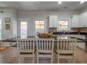 Bright kitchen featuring white cabinetry, granite countertops, an island with barstool seating, and modern appliances at 1871 Shiloh Valley Nw Way, Kennesaw, GA 30144