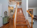 Elegant staircase with wooden steps, white banisters, and a view of the upper level landing at 1871 Shiloh Valley Nw Way, Kennesaw, GA 30144