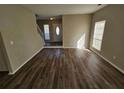 Bright living room boasts new hardwood flooring and ample natural light from a large front window at 6406 Laurel Post Dr, Lithonia, GA 30058