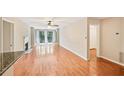 Spacious living room featuring hardwood floors, a cozy fireplace, and natural light from the sliding glass door at 2303 Pine Heights Ne Dr, Atlanta, GA 30324