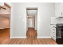 Hallway features wood floors, neutral paint and leads to the home's front door and other rooms at 2938 Parkwood Rd, Snellville, GA 30039