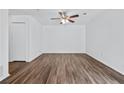 Bright bedroom with ceiling fan, closet, and wood-look floors for a clean, modern feel at 49 Country Ct, Alpharetta, GA 30005