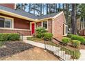 Attractive townhome with well-maintained landscaping and a vibrant red front door at 49 Country Ct, Alpharetta, GA 30005