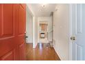 Inviting foyer with hardwood floors leading to a kitchen view and staircase at 7324 Drake Ave, Lithonia, GA 30058
