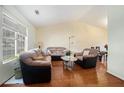 Bright living room featuring hardwood floors, large window, and comfortable seating at 7324 Drake Ave, Lithonia, GA 30058
