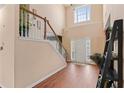 Bright foyer with hardwood floors, staircase, and high ceilings at 765 Rock Ln, Mcdonough, GA 30253