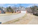 Attractive two-story home featuring a two car garage, well maintained lawn and a long driveway at 1092 Shumard Ln, Mcdonough, GA 30252