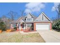 Inviting two-story home with brick and gray siding, manicured front yard, and attached two-car garage at 1092 Shumard Ln, Mcdonough, GA 30252