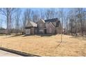 Well-maintained two-story brick home with a manicured front yard and mature trees at 25 Mountain Crest Dr, Oxford, GA 30054