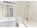 Bathroom with white vanity, mirror, and tub with shower head at 1166 Booth Sw Rd # 605, Marietta, GA 30008