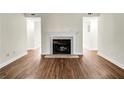 Living room with fireplace, mantle and tile hearth with updated laminate flooring at 1166 Booth Sw Rd # 605, Marietta, GA 30008