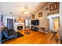 Bright living room with vaulted ceiling, hardwood floors, fireplace, and neutral paint at 7617 Lakemoor Dr, Riverdale, GA 30296