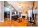 Inviting living room flows into the kitchen, featuring hardwood floors and a fireplace at 7617 Lakemoor Dr, Riverdale, GA 30296