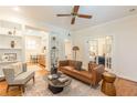 Cozy living room featuring hardwood floors, built-in bookshelves, and view into adjacent room through double doors at 1015 Piedmont Ne Ave # A2, Atlanta, GA 30309