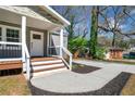 Close up of front porch with white trim and wooden decking at 1947 Maywood Nw Pl, Atlanta, GA 30318